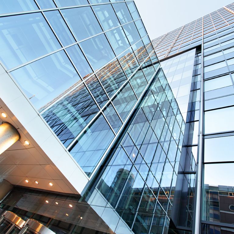 The sale of non-performing real estate portfolios: People standing in the entrance of an office building.