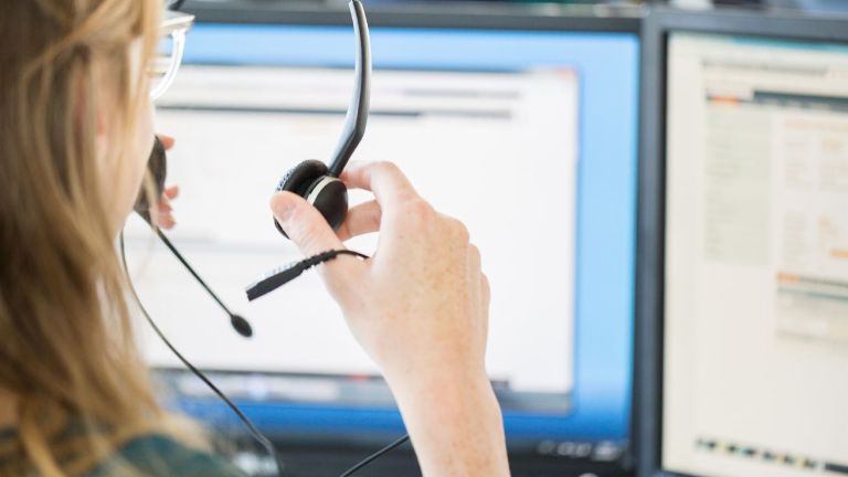 Artificial intelligence in the call center. A call center agent puts on her headset.
