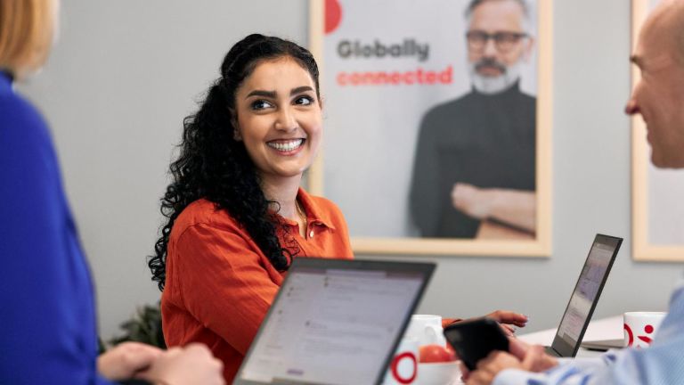 Three EOS colleagues working together, woman in focus.