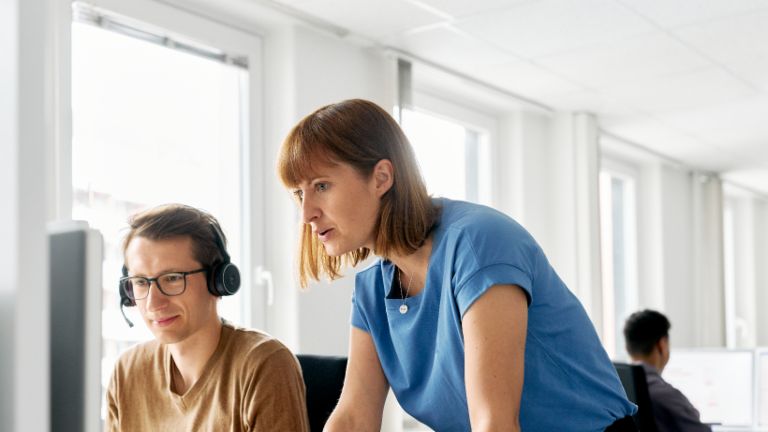 EOS employee explains something to a colleague