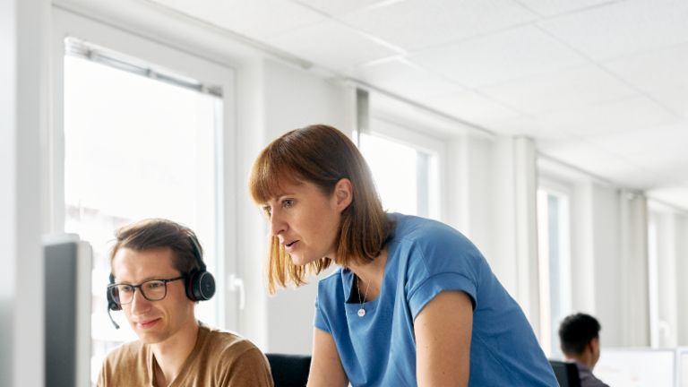 EOS employee explains something to a colleague